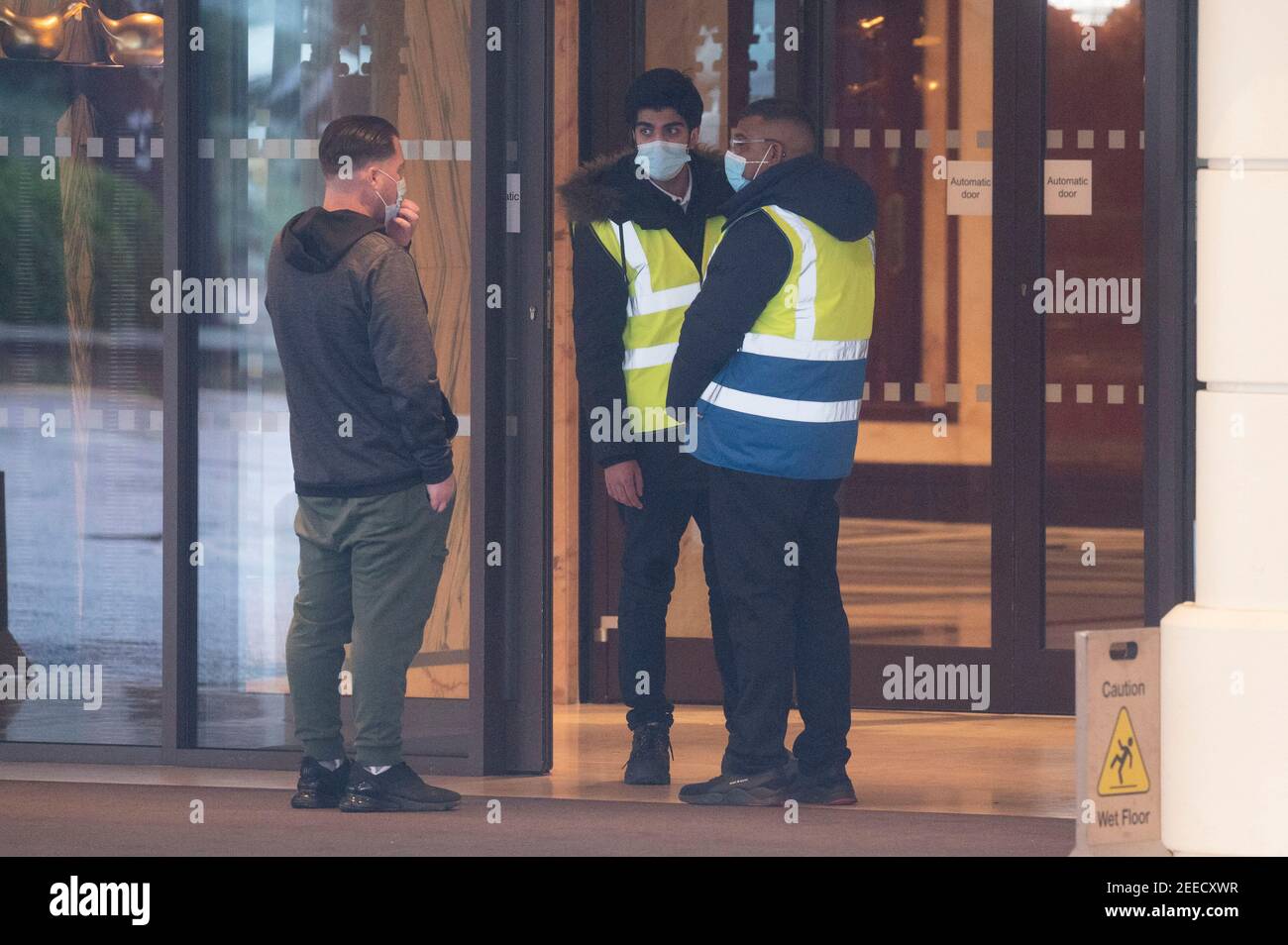 London, Britain. 15th Feb, 2021. Security staff guard the entrance of the Radisson Blu Edwardian Hotel in London, Britain, on Feb. 15, 2021. From Monday, all British and Irish citizens and British residents who arrive in England after being in the 'red list' of more than 30 high-risk countries now have to self-isolate in hotels. The 'red list' countries include South Africa, Portugal and South American nations. Credit: Ray Tang/Xinhua/Alamy Live News Stock Photo