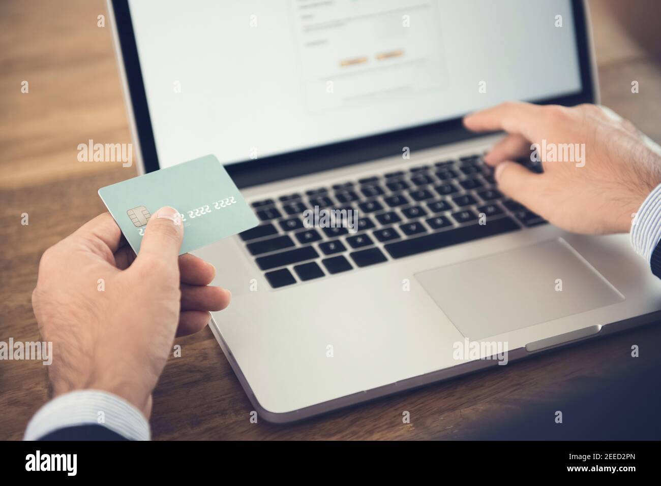 Businessman using laptop computer shopping online and paying with credit card - financial technology (or fintech) concept Stock Photo