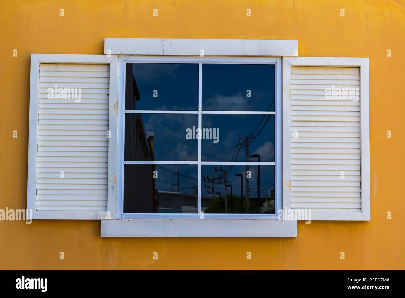 White windows and yellow color wall background Stock Photo - Alamy