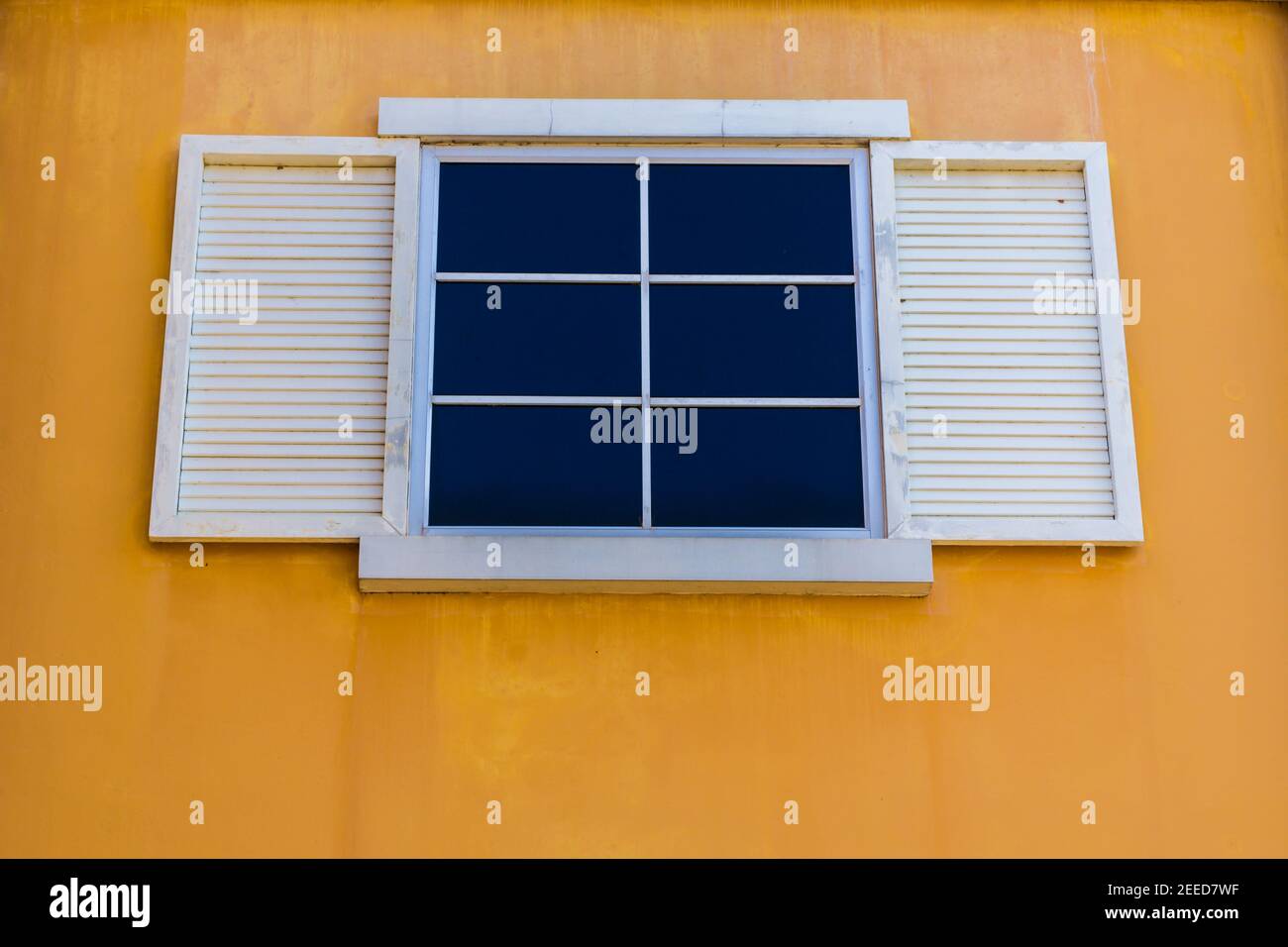 White windows and yellow color wall background Stock Photo - Alamy