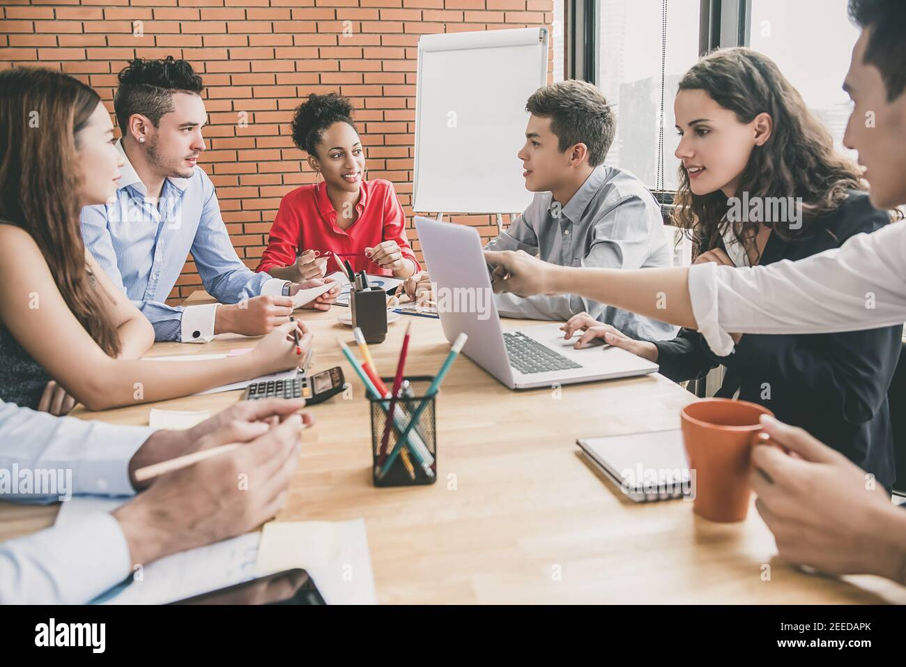 Group of multiethnic business team brainstorming and discussing project ...