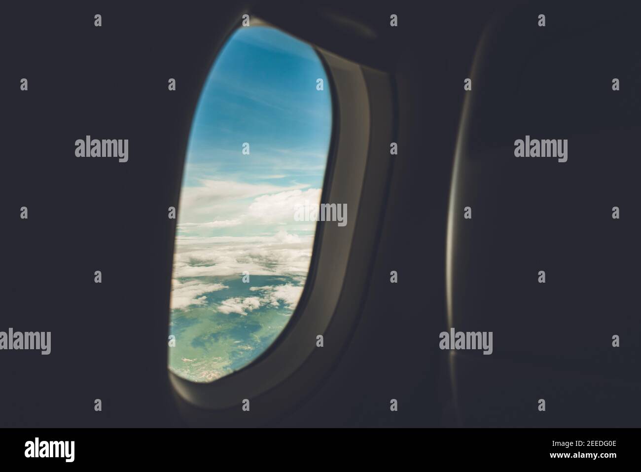 Beautiful nature scenery looking through open window of the airplane from the cabin, passenger view while traveling on board Stock Photo