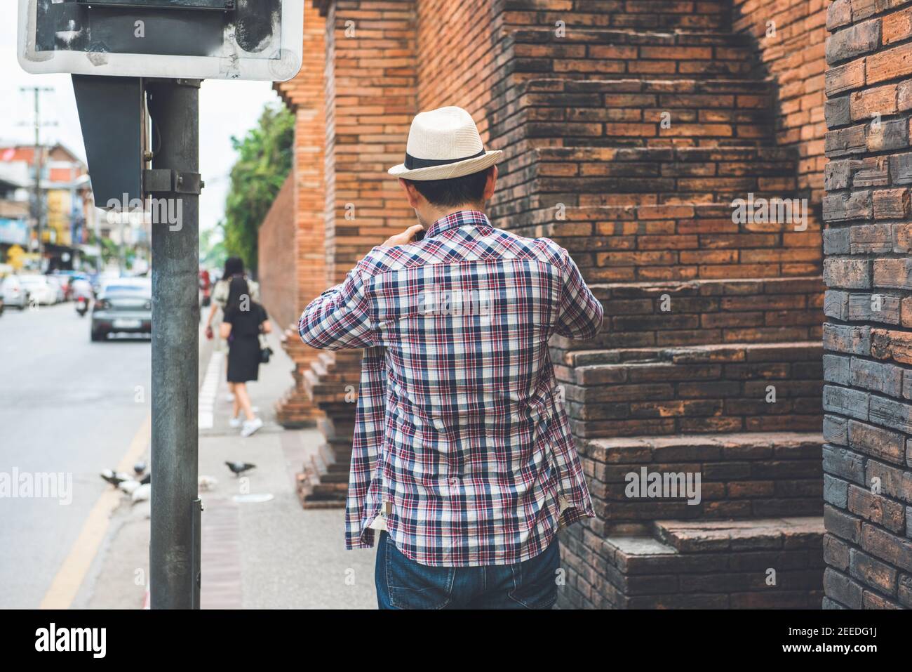 Asian male tourist taking picture of Tha Phae Gate, one of the ancient famous landmark of the city in Chiang Mai Thailand Stock Photo