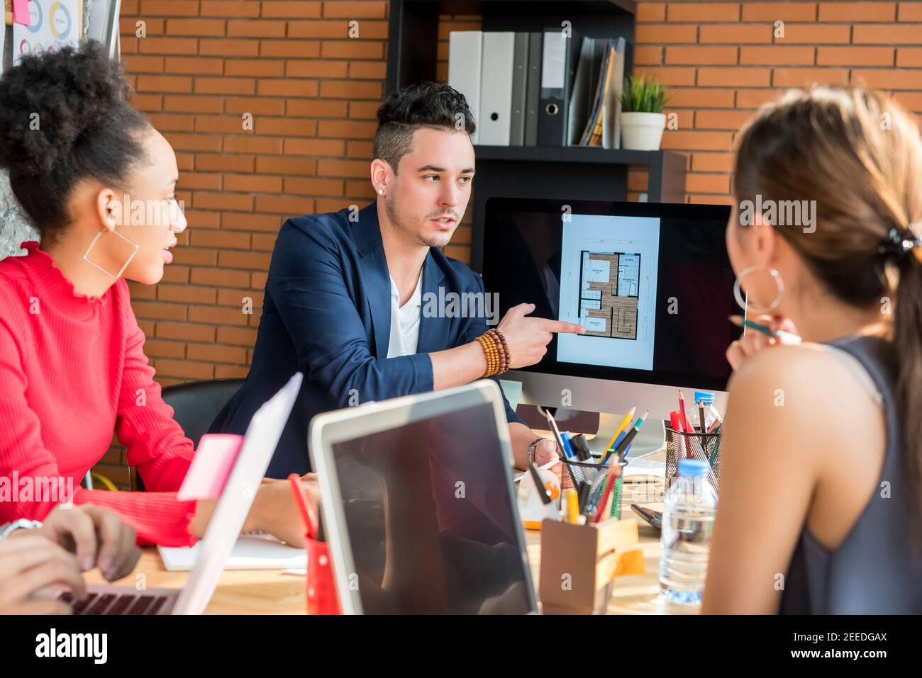 Multiethnic architects or interior designer team discussing project together in the meeting Stock Photo