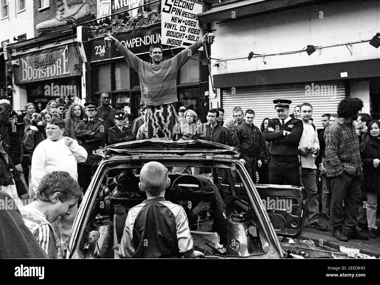 Police officers watching the crowd at the Camden High Street Reclaim The Streets anti car protest, London, 14th May 1995 Stock Photo
