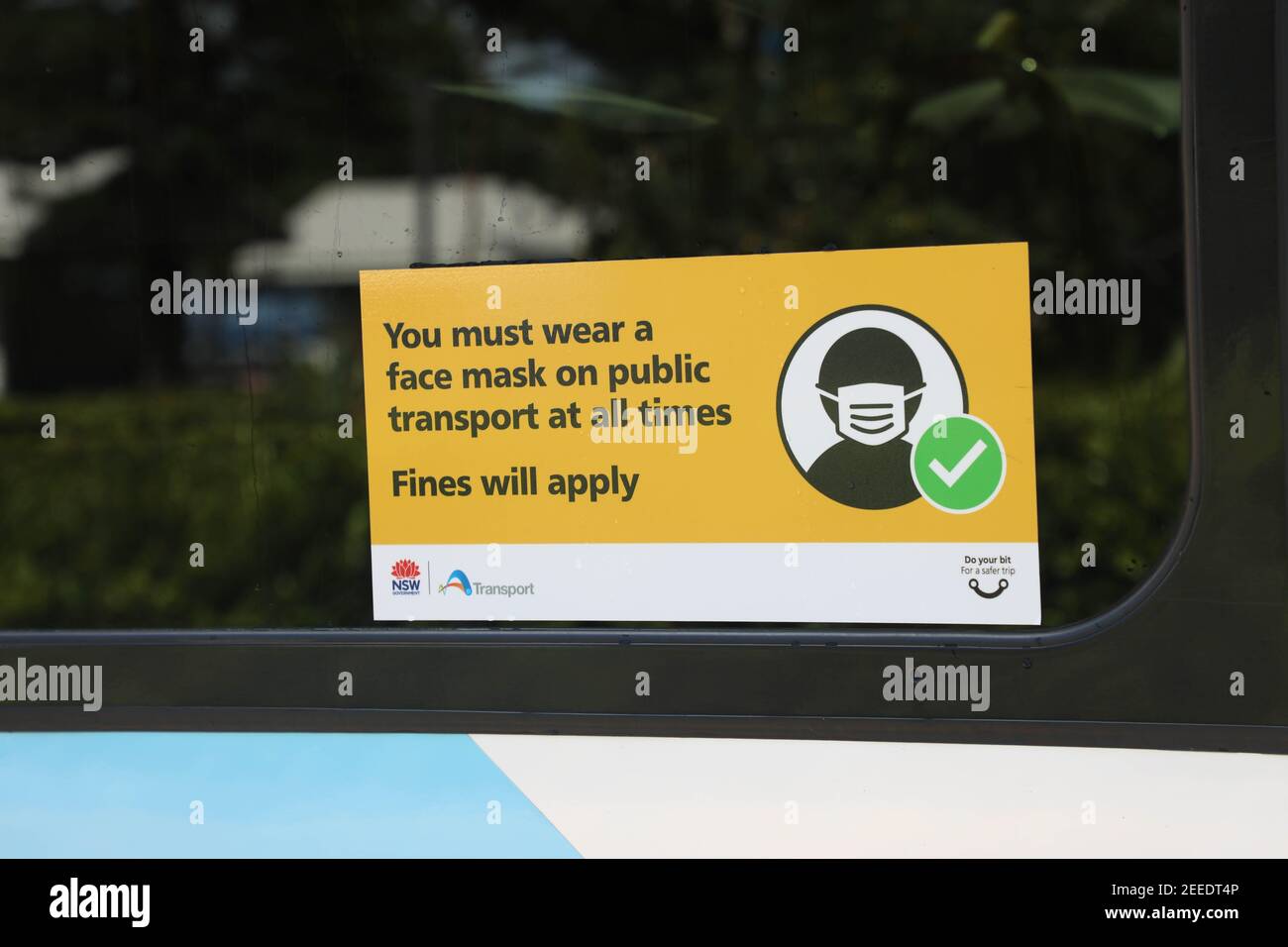 Sign on the side of buses telling people they must wear a face mask on