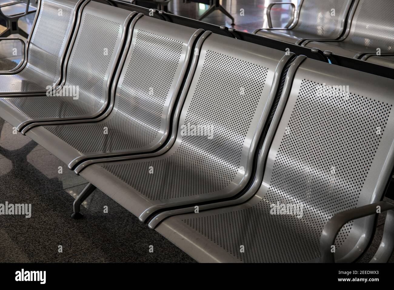 Metallic chair row for airport customers. Modern public place asset