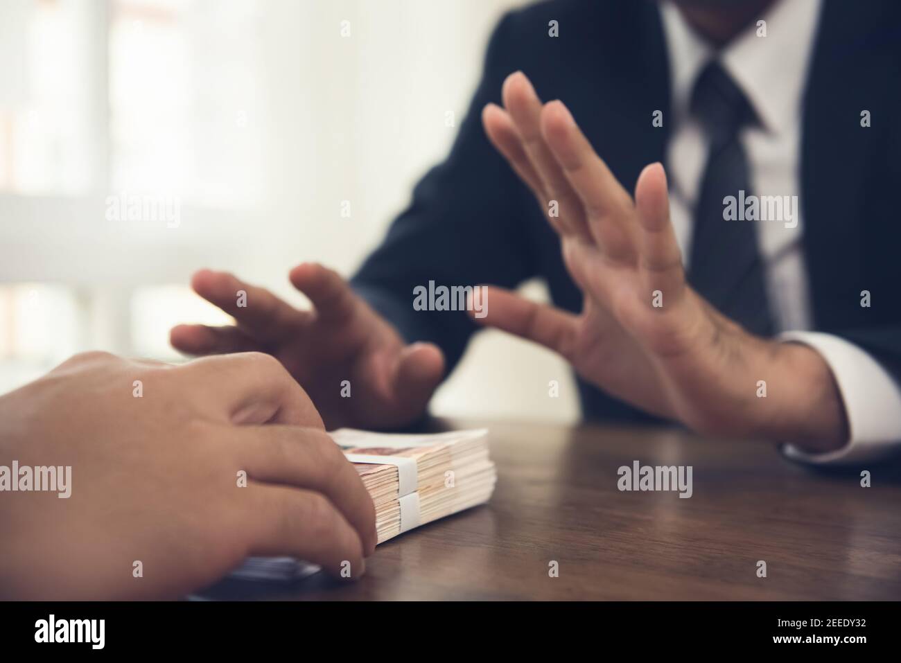 Businessman rejecting money offered by his partner - anti bribery concept Stock Photo