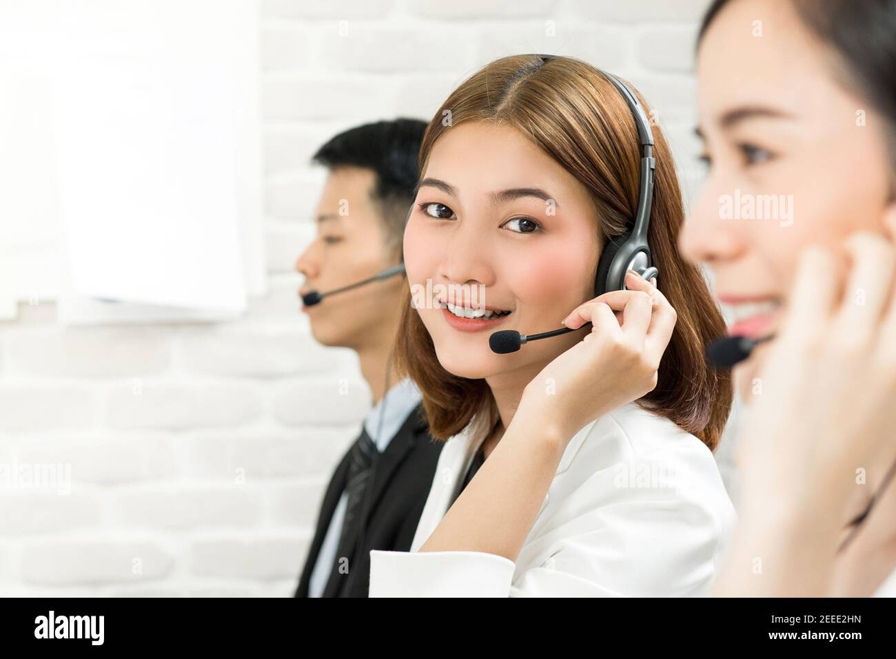 Smiling beautiful Asian woman telemarketing customer service agent