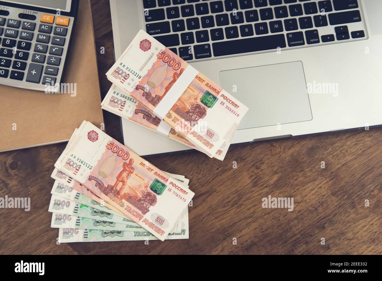 Money, Russian Ruble currency, on laptop computer at working table - investment and financial management concepts Stock Photo