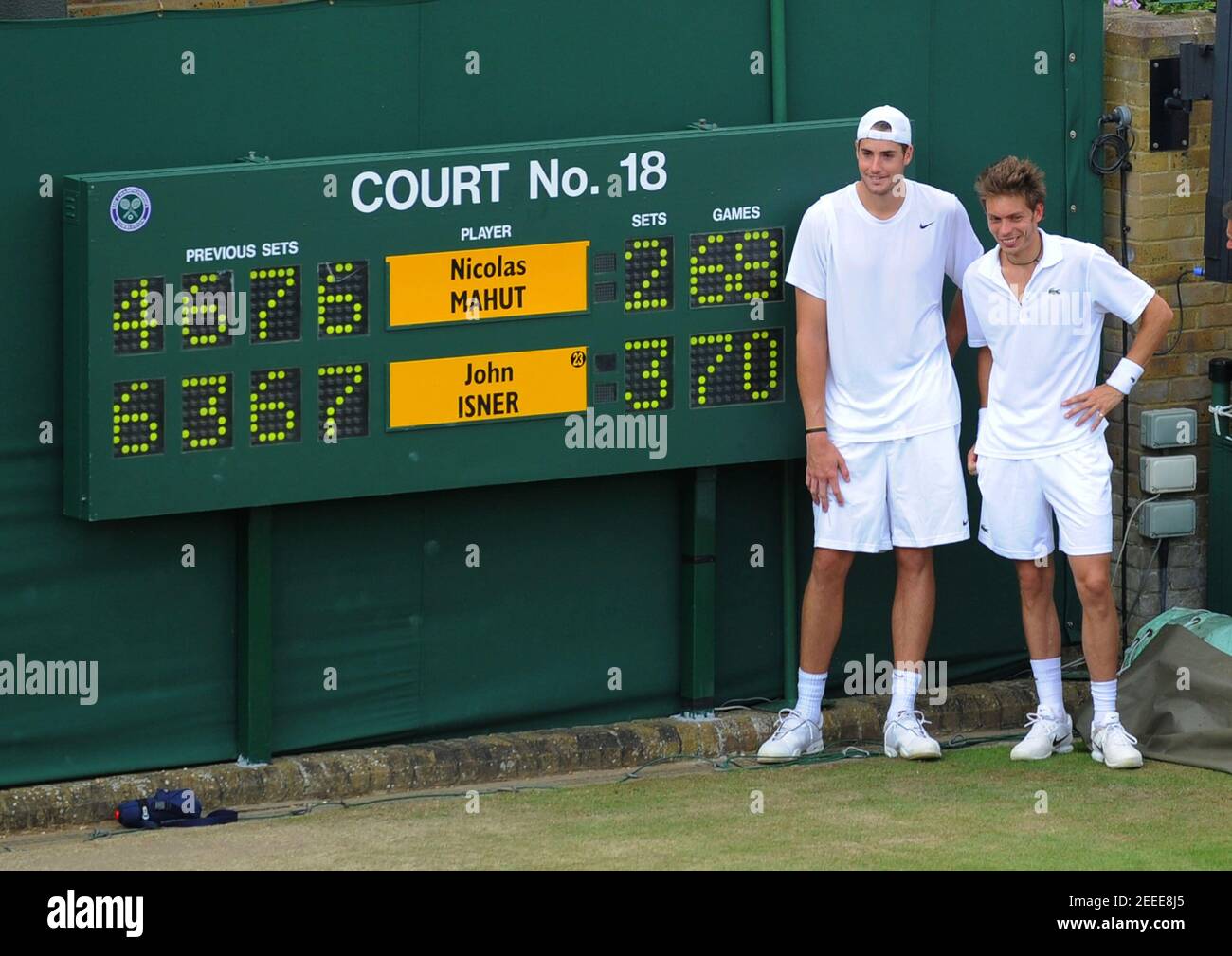 Tennis - Wimbledon - All England Lawn Tennis & Croquet Club, Wimbledon,  England - 24/6/10 John Isner of USA (L) and Nicolas Mahut of France stand  next to the scoreboard after their