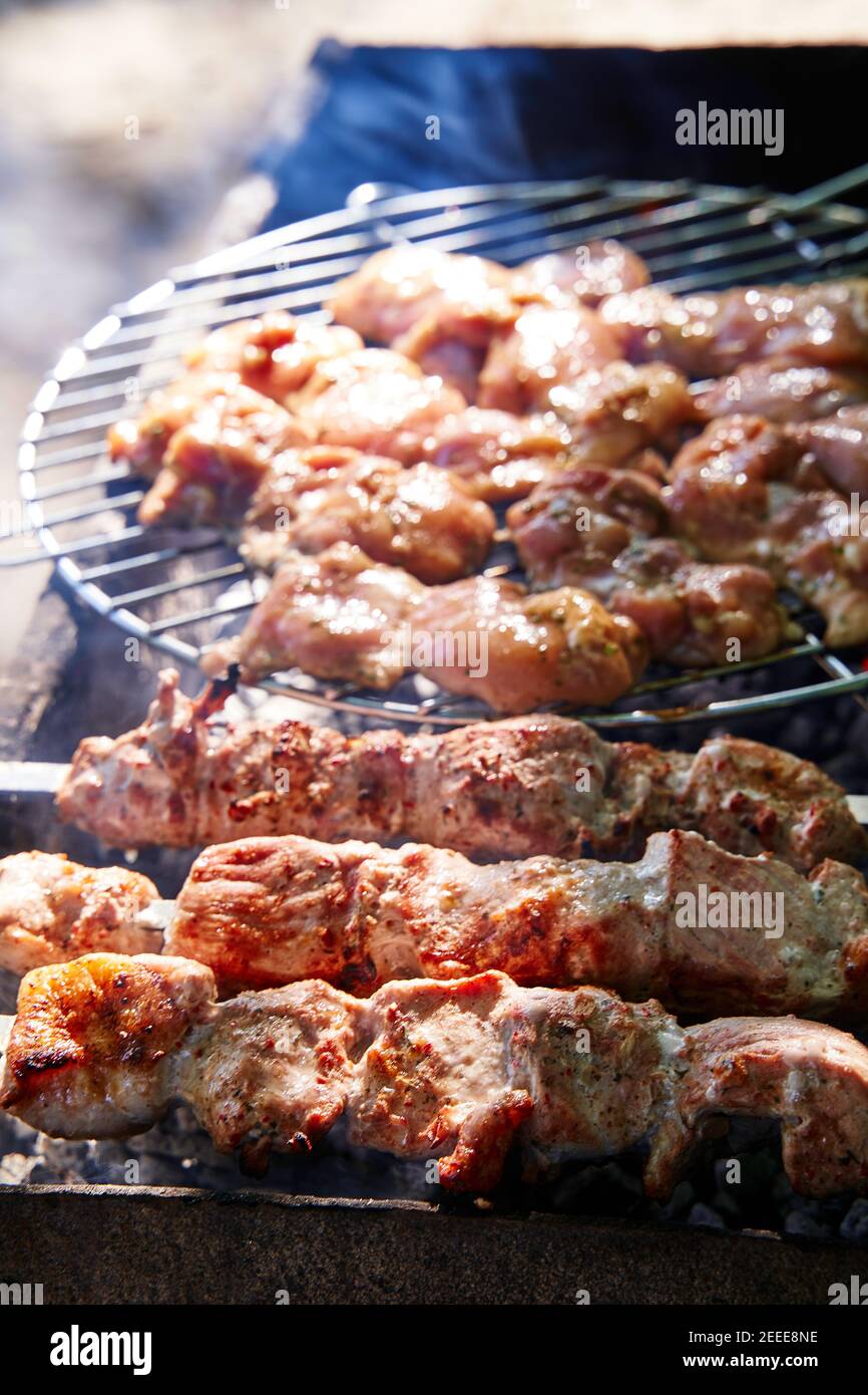 Grilled kebab cooking on metal skewer. Roasted meat cooked at barbecue