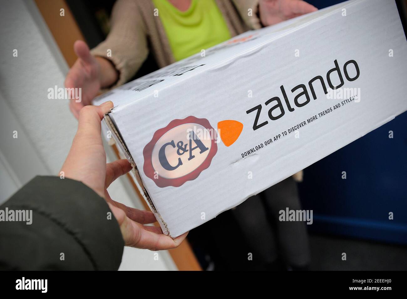 Munich, Deutschland. 16th Feb, 2021. PHOTOMONTAGE: Retail under pressure  Fashion chain C&A is now also selling at Zalando. Zalando parcel is  received, online mail order company for shoes and fashion. | usage