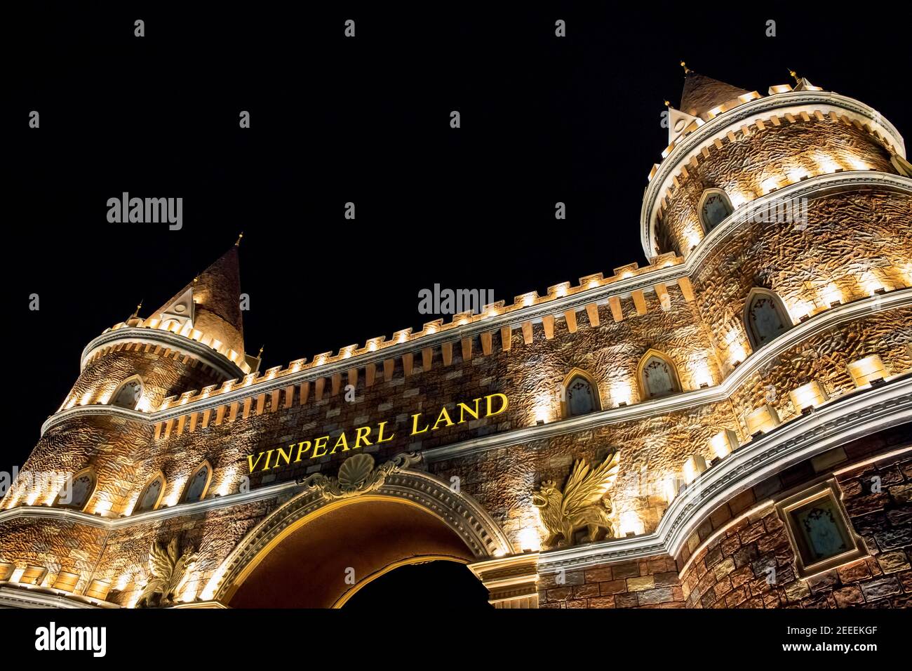 Nha Trang, Vietnam - 24 July, 2019: Amusement Park Vinpearl land, signboard at night time. Evening at Vinpearl adventure park. Fantastic medieval arch Stock Photo