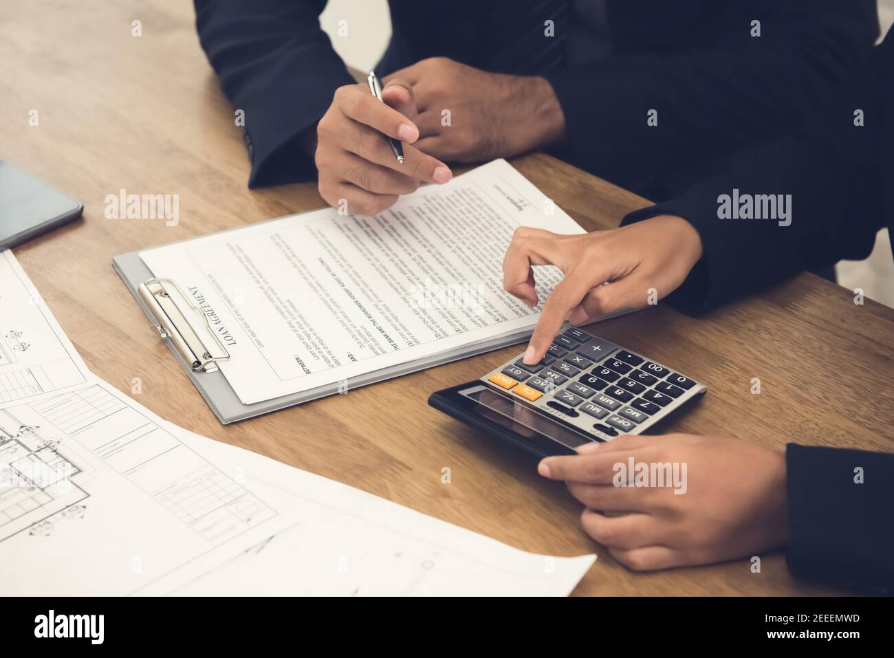 Client consulting with real estate agent about loan agreement Stock Photo