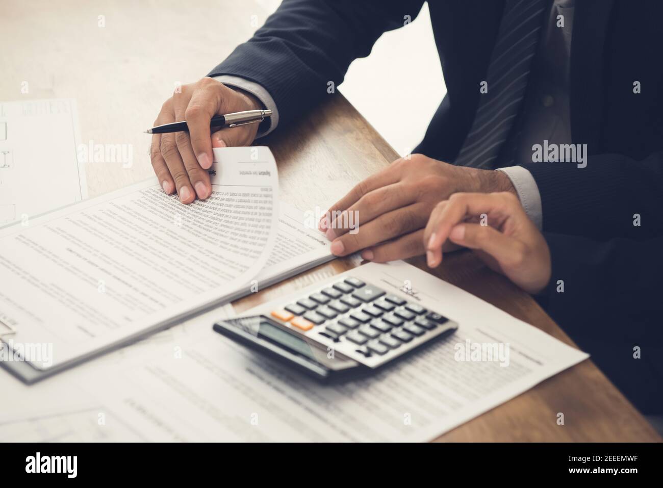Client consulting with agent, reviewing contract about to sign Stock Photo
