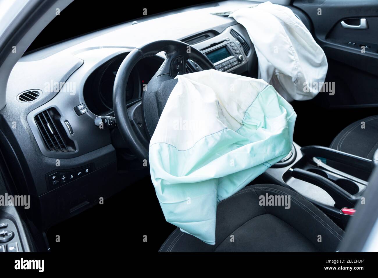 Airbag exploded at a car after the accident. Driver and Passenger