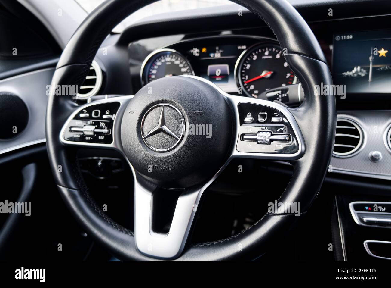 Sankt-Petersburg, Russia, February 10, 2021: Dashboard and steering wheel with media control buttons of a Mercedes Benz E-class . Car interior detais Stock Photo