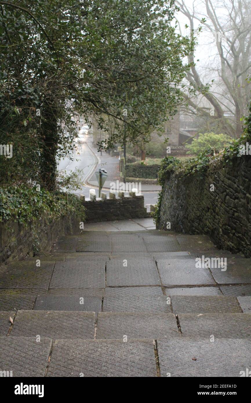 Rural view looking down from textured steps towards the church road