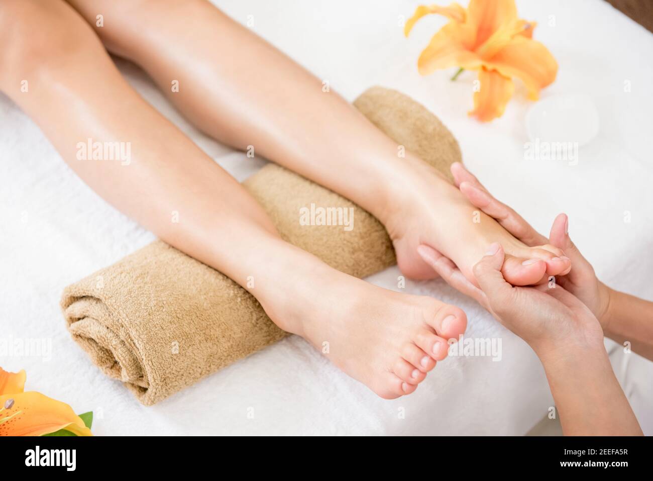 Therapist giving foot massage to a woman in spa Stock Photo Alamy