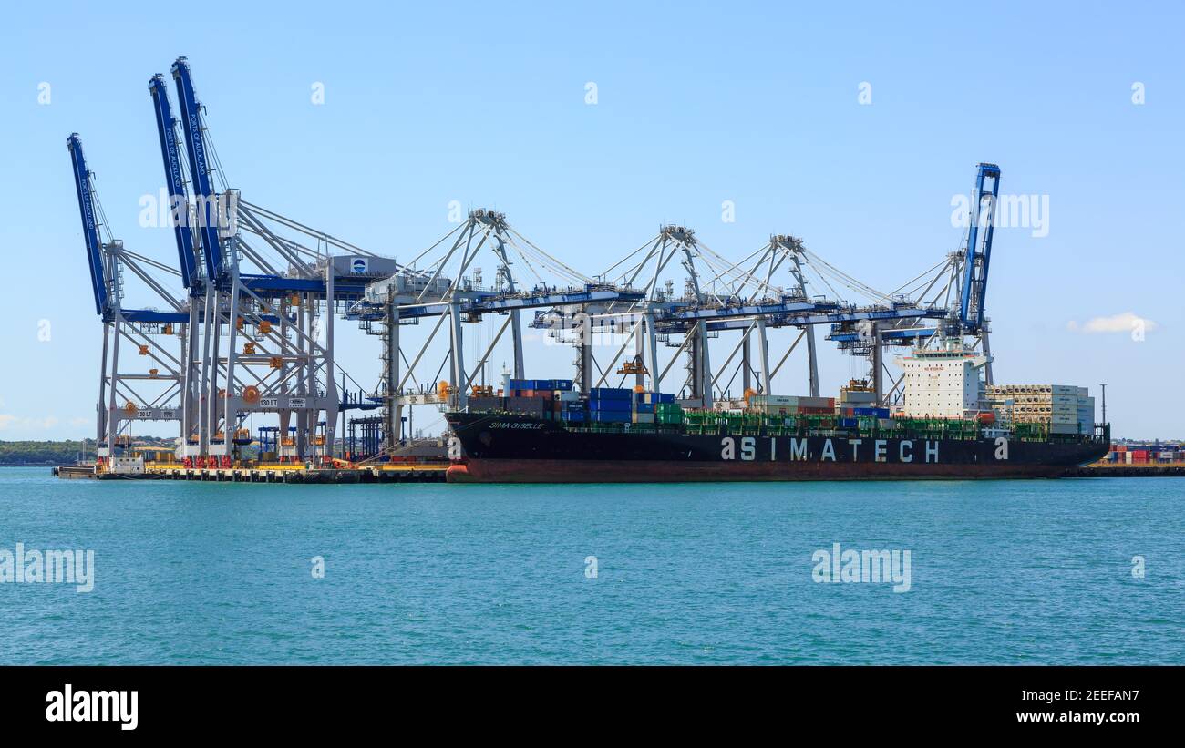 A giant Simatech cargo ship moored underneath the cranes of the Fergusson Container Terminal, Auckland, New Zealand Stock Photo