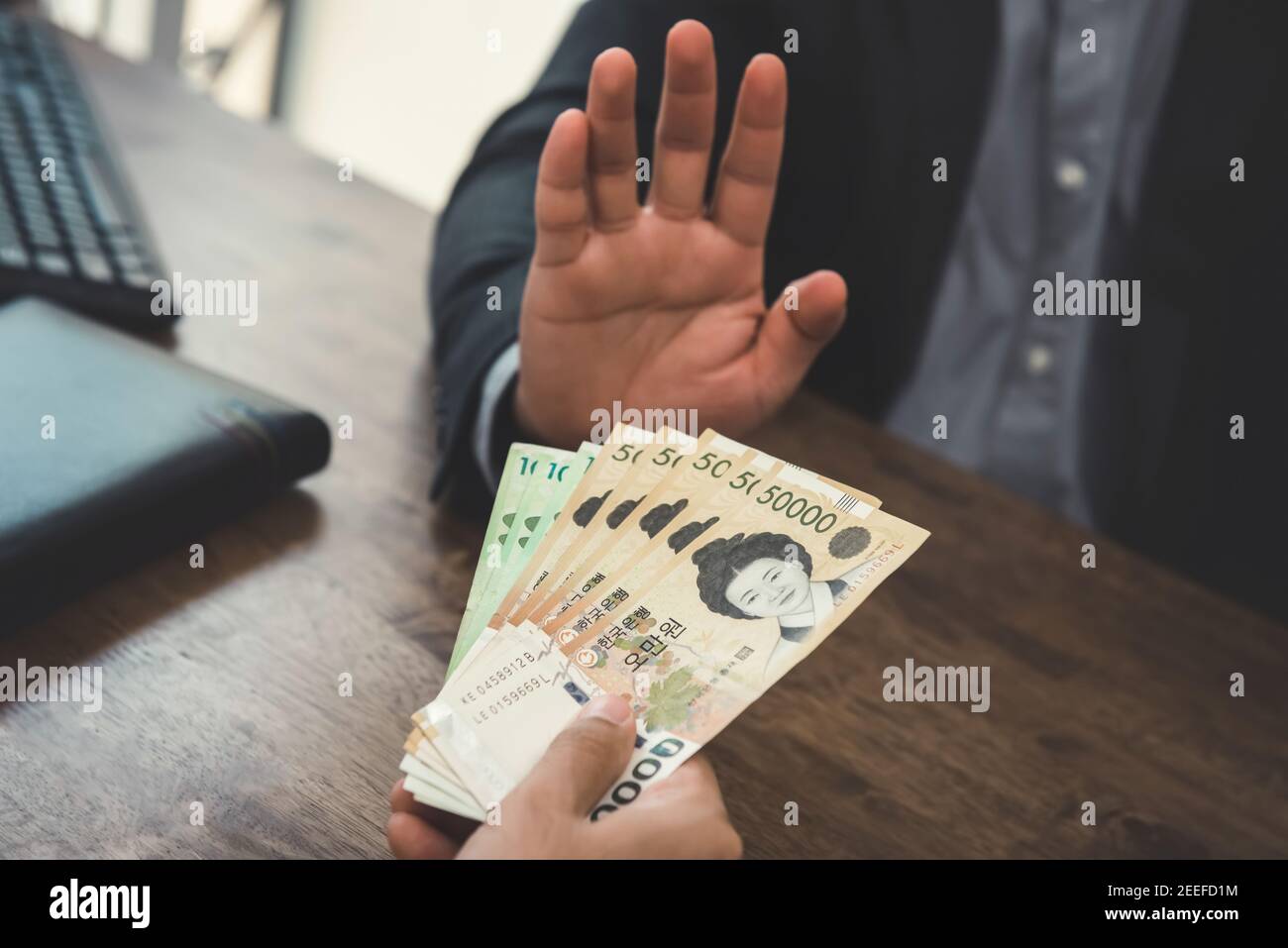 Businessman rejecting money - anti bribery concept Stock Photo