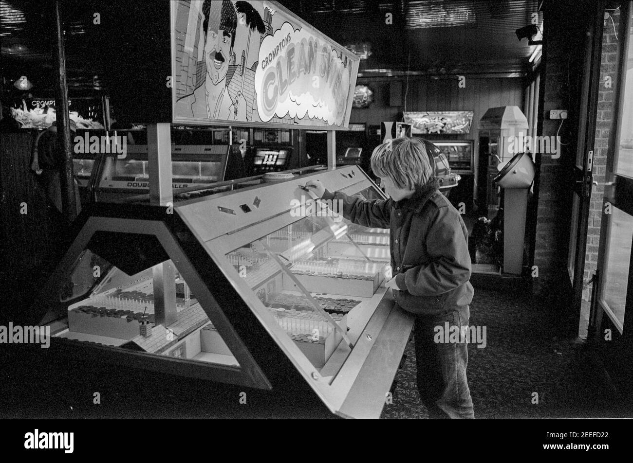 Young Boy Feeding pennies to Clean Sweep Machine Stock Photo - Alamy