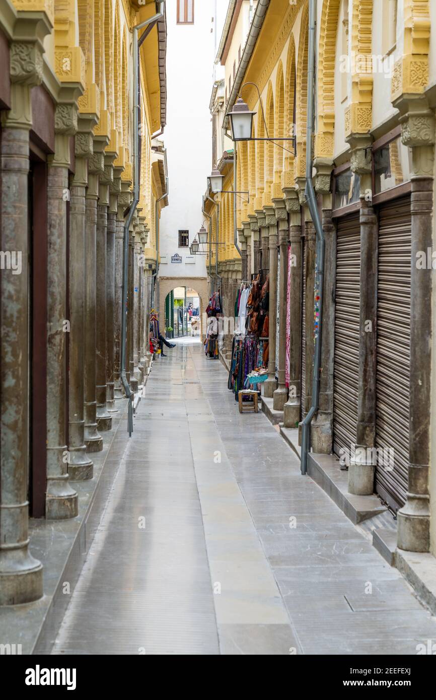 Granada, Spain - 4 February, 2021: An empty and narrow pedestrian alley in the heart of the old city center in Granada Stock Photo
