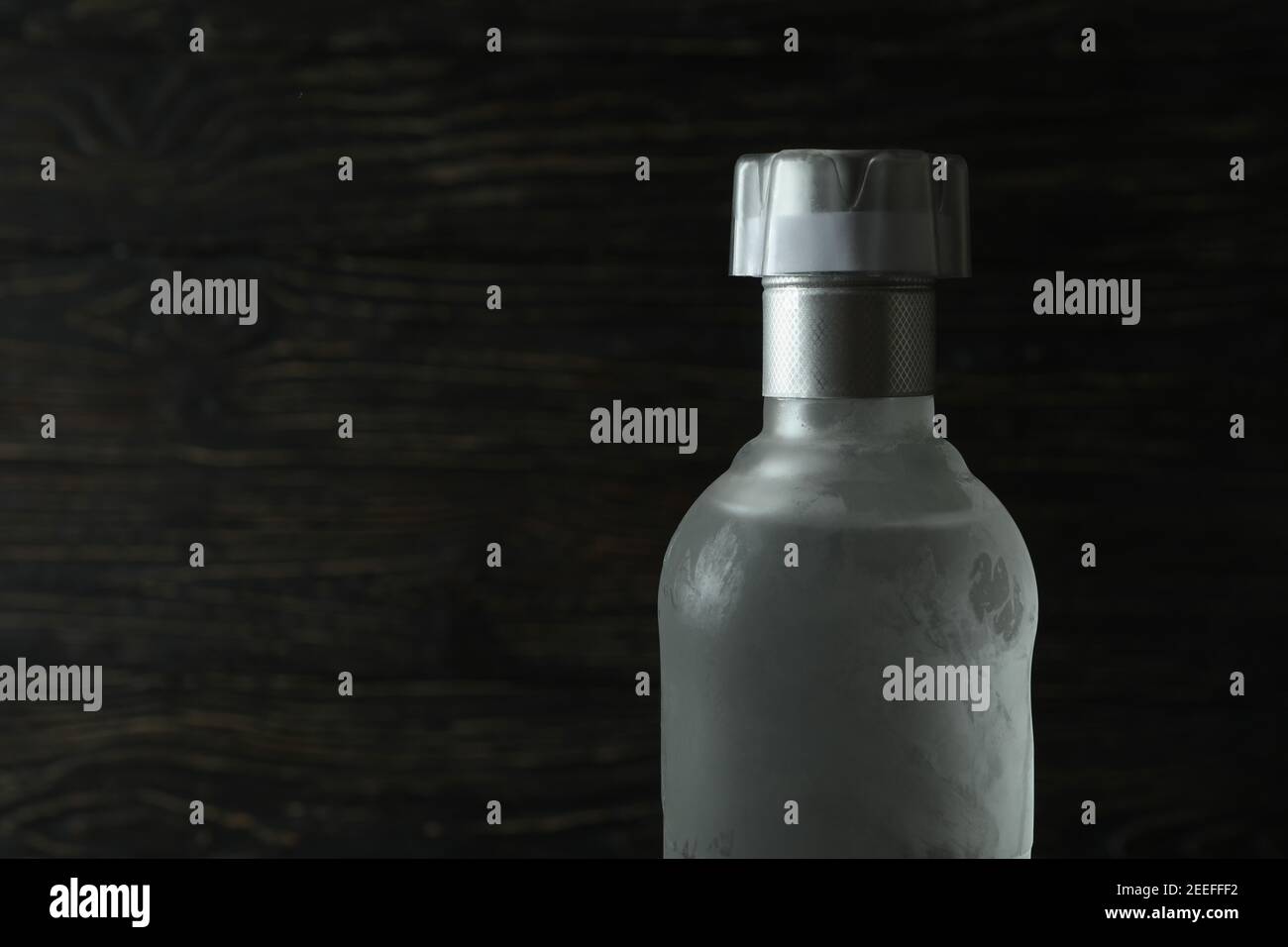 Blank bottle of vodka on wooden background, space for text Stock Photo