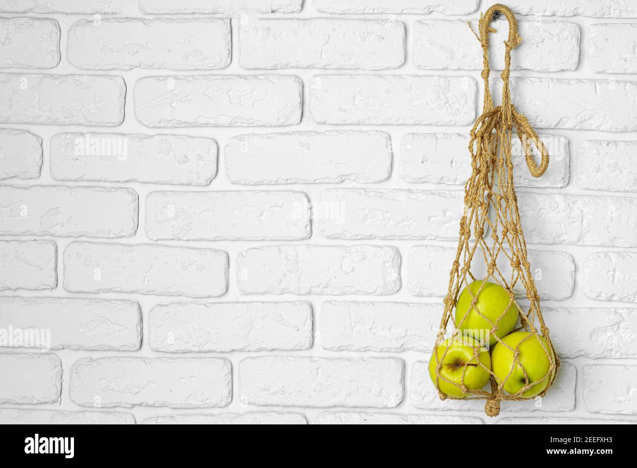 Ripe green apples in a light string bag Stock Photo