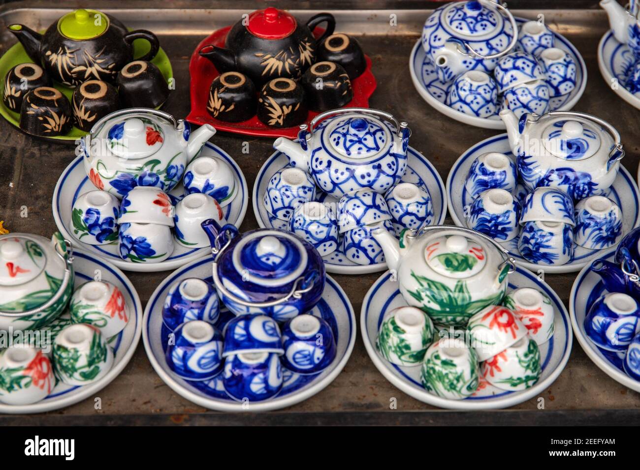 Small tea sets for sale on tourist market. Ceramic tea pot and cup with