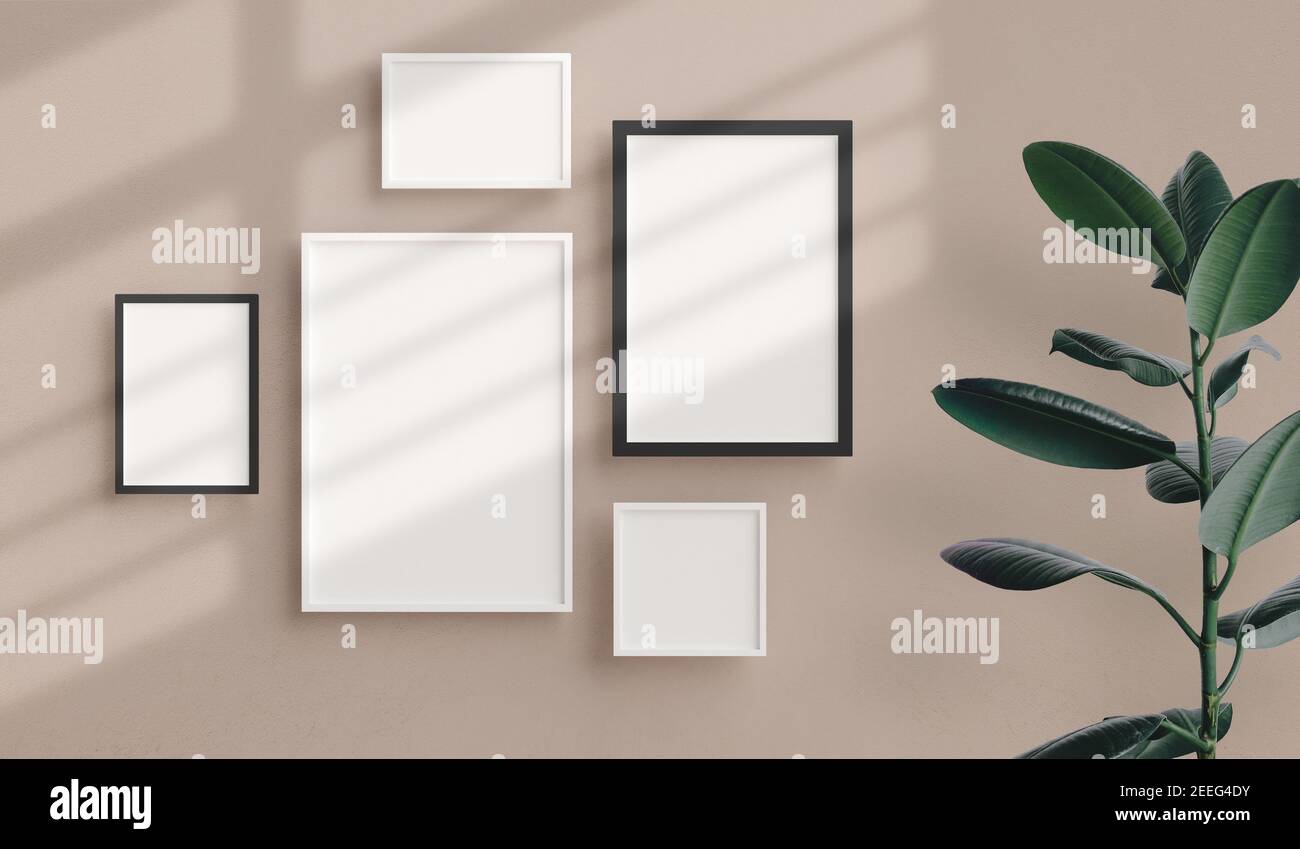 Various sizes of minimal photo frames mockup hanging on the apartment wall. Modern home interior design, blank empty frame template, nordic style Stock Photo