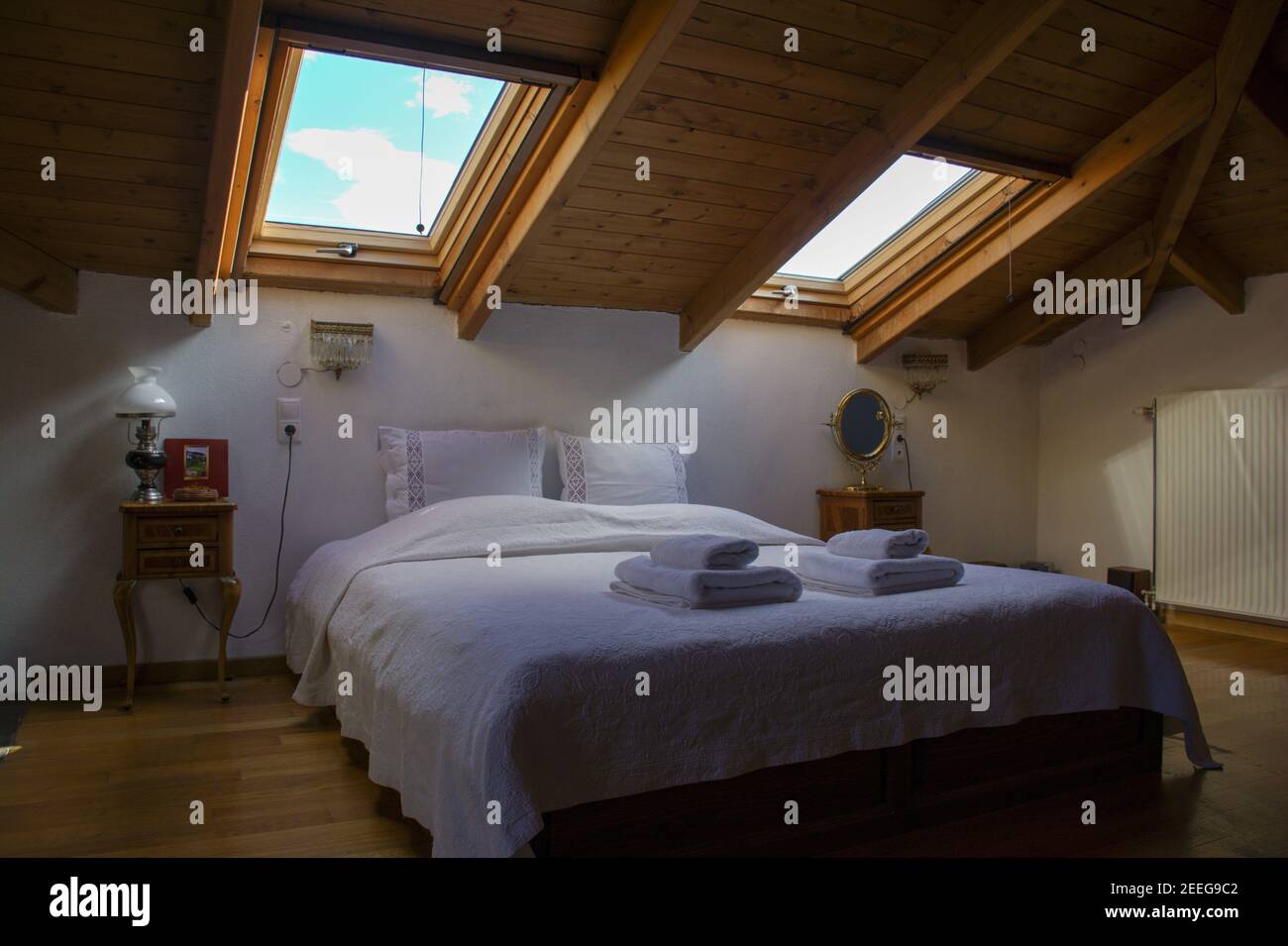 Cozy attic empty hotel bedroom Stock Photo - Alamy