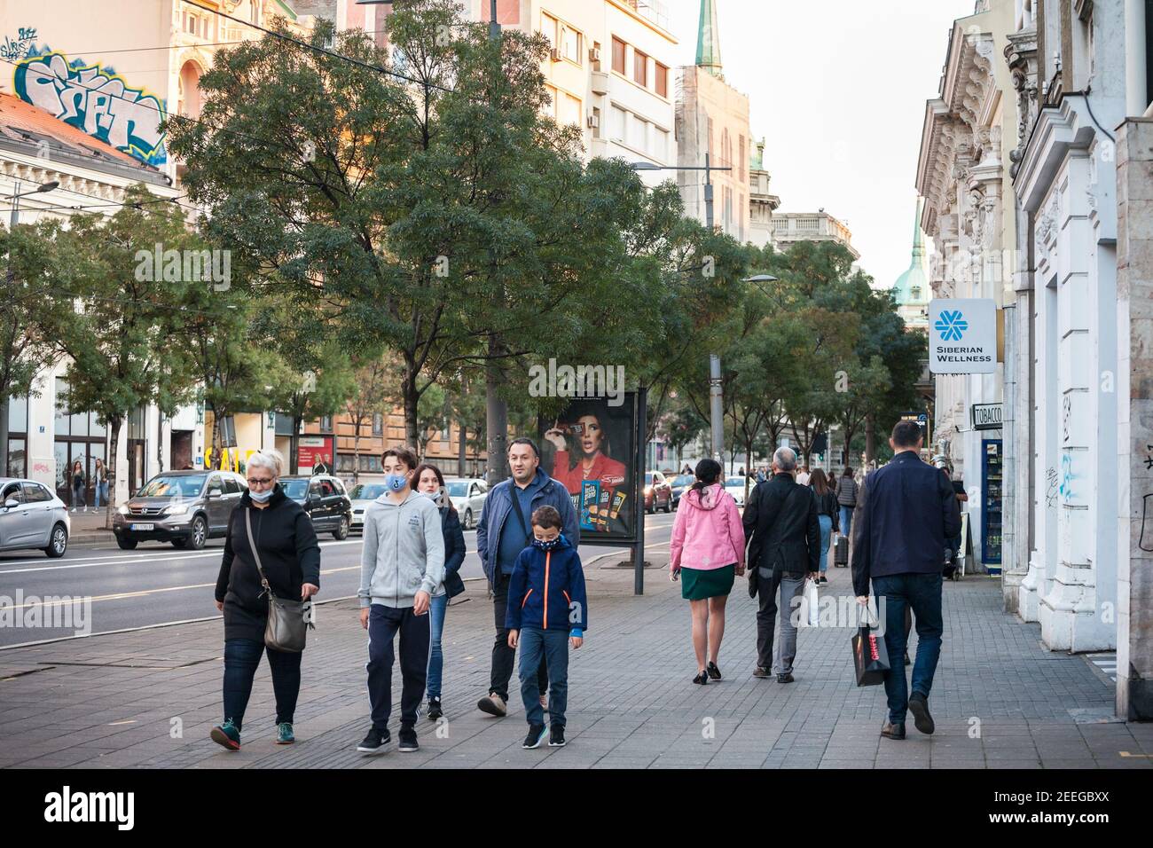 BELGRADE, SERBIA - OCTOBER 10, 2020: Family, a mother, father, man, woman, and their kidswalking wearing with only few persons wearing face mask prote Stock Photo