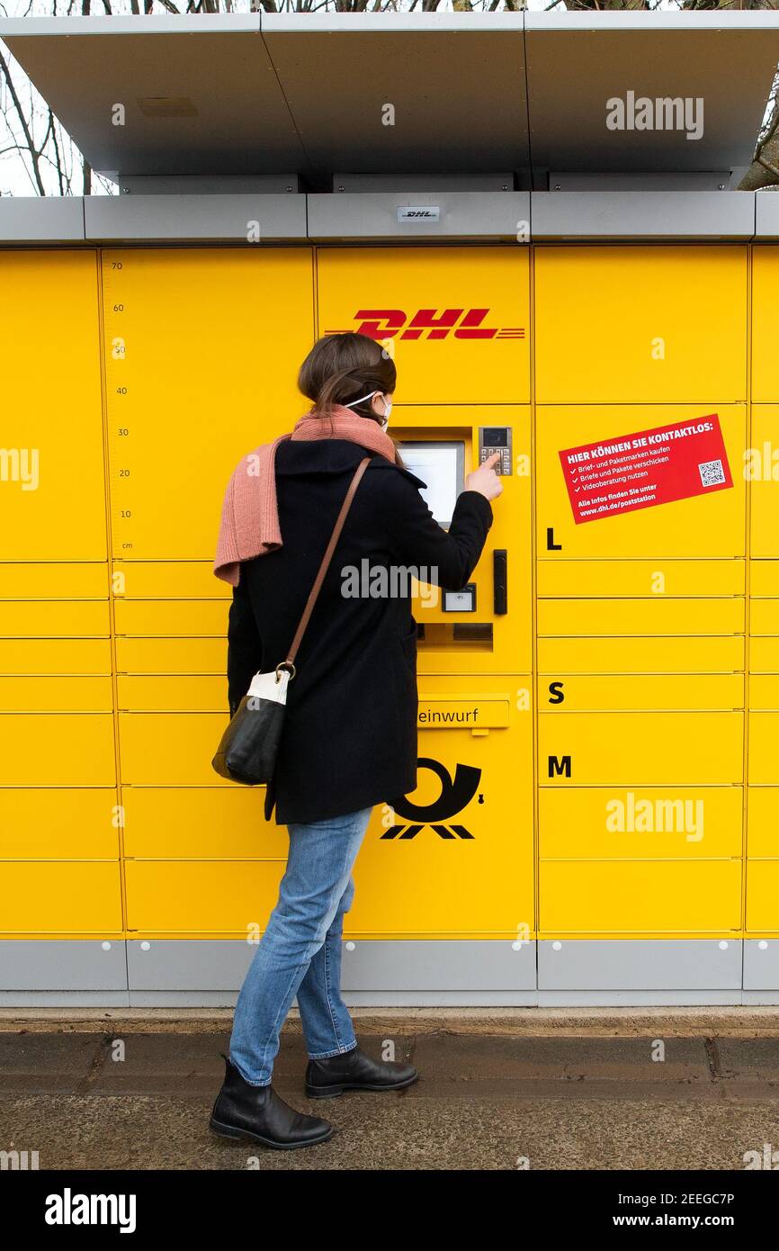 North Rhine-Westphalia, Würselen, 16 February 2021, A Post employee  operates a new postal station. The yellow container is an extension of the  already familiar Packstation. At the new postal station, which has