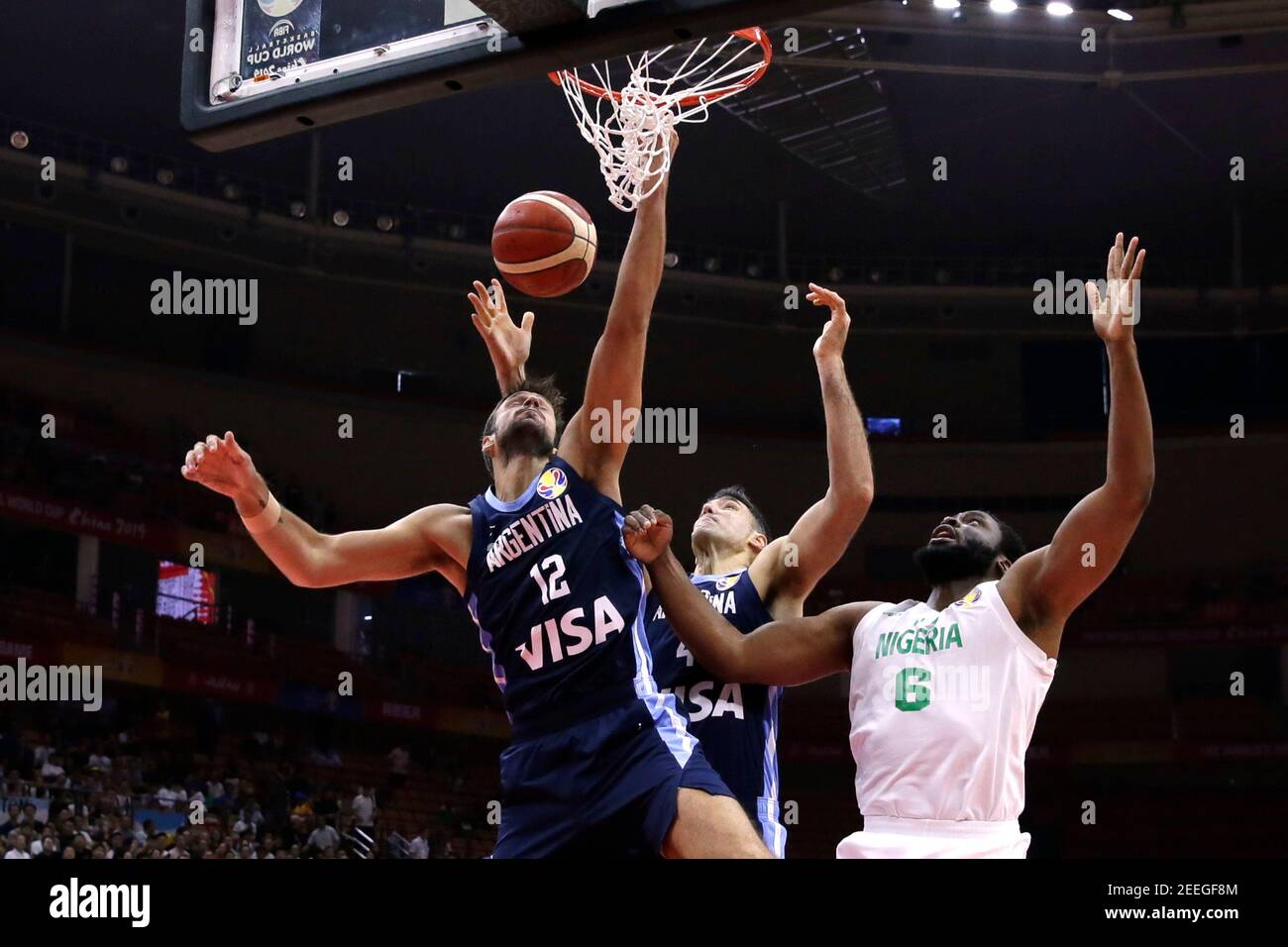 Basketball - FIBA World Cup - First Round - Group B - Nigeria v Argentina - Wuhan Sports Center, Wuhan, China - September 2, 2019 Argentina's Marcos Delia and Luis Scola in action with Nigeria's Ike Diogu REUTERS/Jason Lee Stock Photo