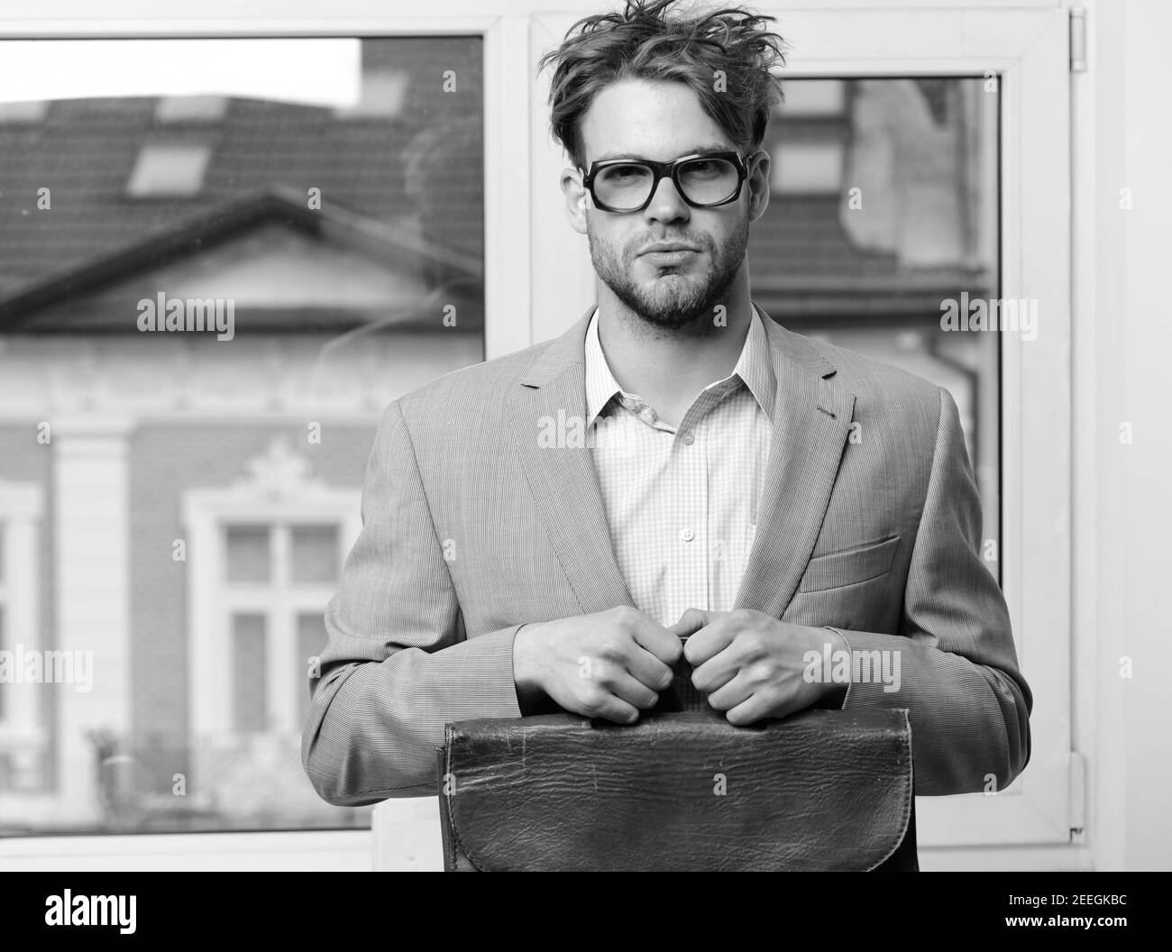 Man with briefcase isolated on white background. Nerd or brainiac