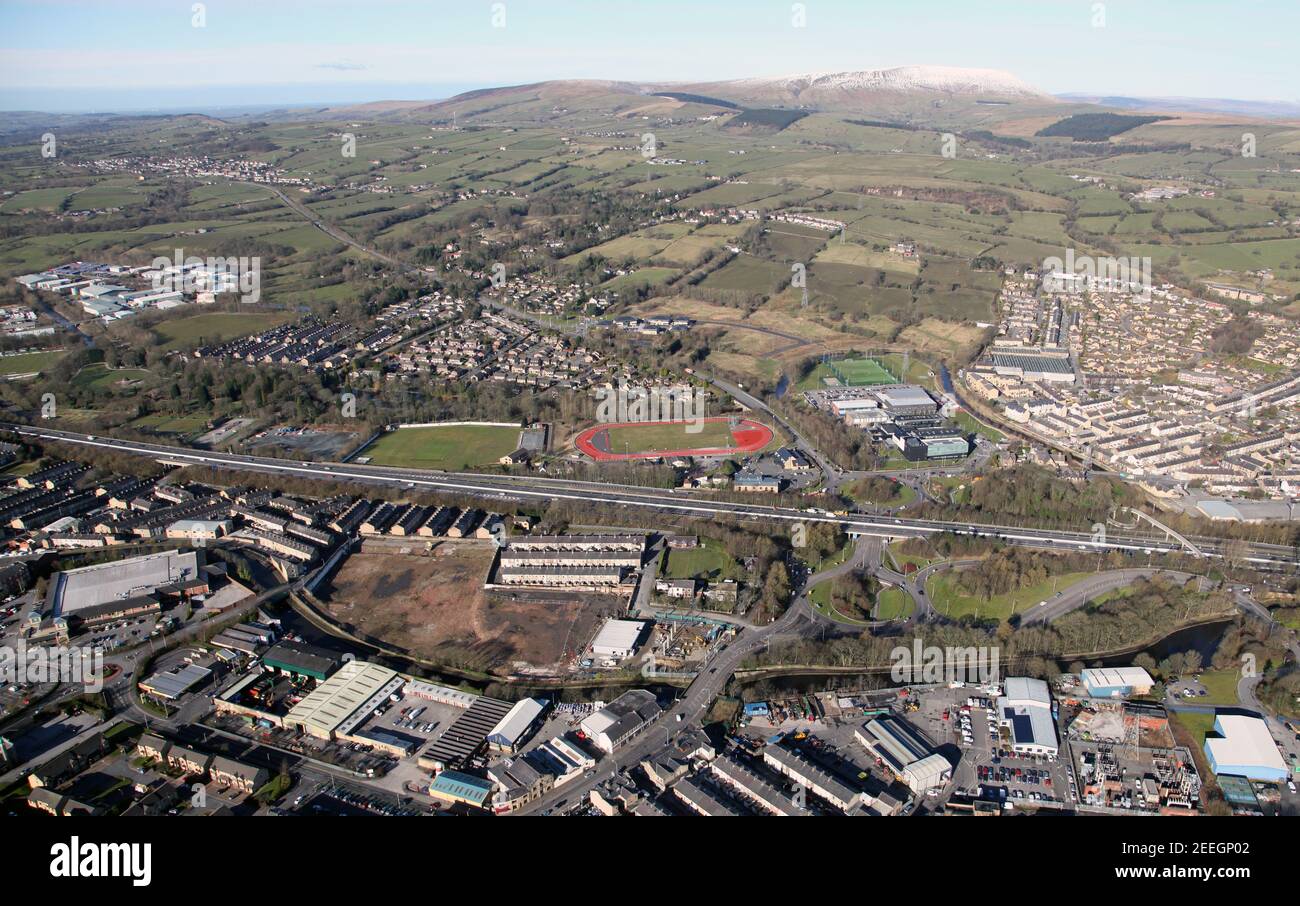 aerial view of Nelson, Lancashire. In view: Hodge Bank Business Park, Nelson & Colne College with running track. Also Pendle Hill in the background Stock Photo