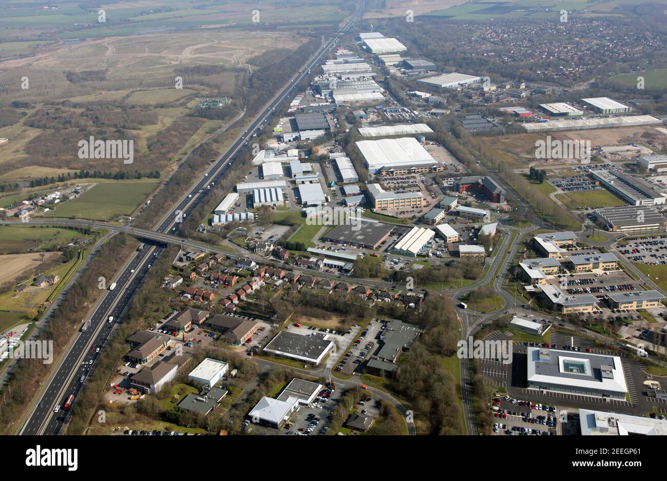 aerial view looking east of the Birchwood (foreground) & Risley (mid foreground & beyond) commercial areas of N Warrington alongside the M62 motorway Stock Photo
