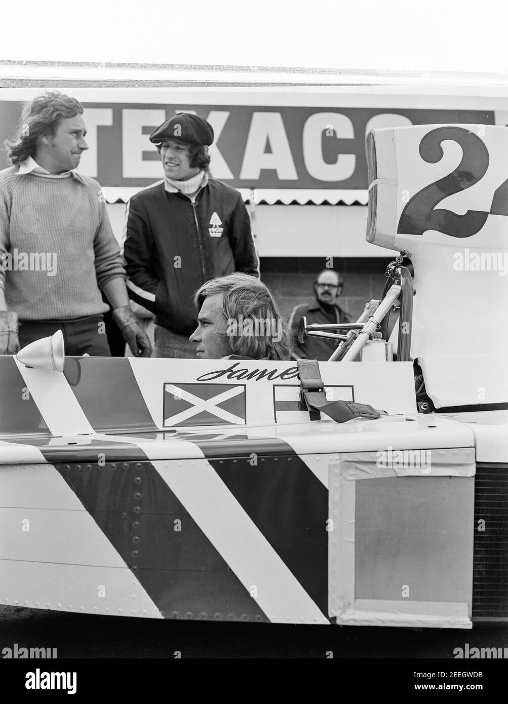 F1 driver James Hunt seated in car for practice at Silverstone race track 12/04/75 1975 Stock Photo