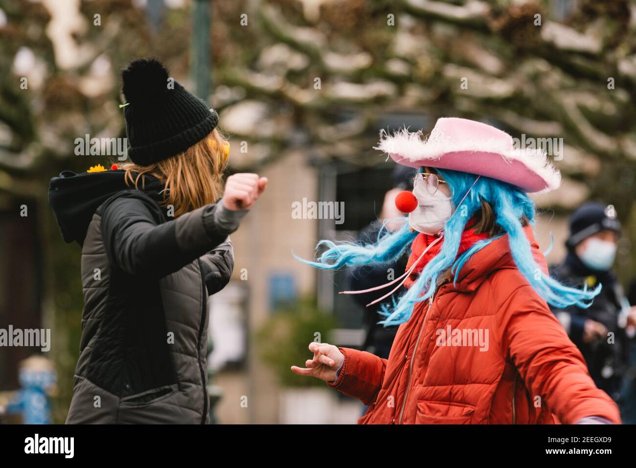 Dusseldorf, Germany. 15th Feb, 2021. People with facial masks dress up during the German carnival season amid COVID-19 pandemic in Dusseldorf, Germany, Feb. 15, 2021. Most of the traditional German carnival activities have been cancelled this year due to the COVID-19 pandemic. Some people dressed up here with sufficient COVID-19 prevention and control measures on Monday. Credit: Tang Ying/Xinhua/Alamy Live News Stock Photo