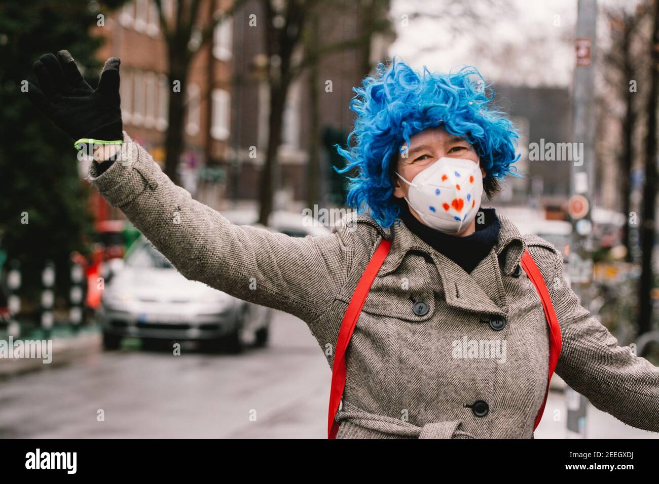 Dusseldorf, Germany. 15th Feb, 2021. A woman with facial mask dresses up during the German carnival season amid COVID-19 pandemic in Dusseldorf, Germany, Feb. 15, 2021. Most of the traditional German carnival activities have been cancelled this year due to the COVID-19 pandemic. Some people dressed up here with sufficient COVID-19 prevention and control measures on Monday. Credit: Tang Ying/Xinhua/Alamy Live News Stock Photo
