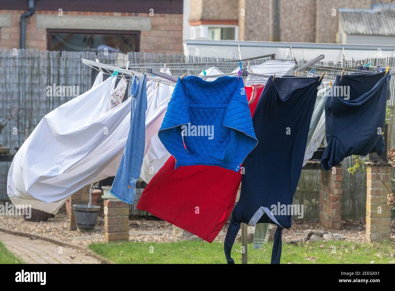 Washing hang on a rotary cloths line blowing in the wind in a backgarden, Northampton, England, UK. Stock Photo