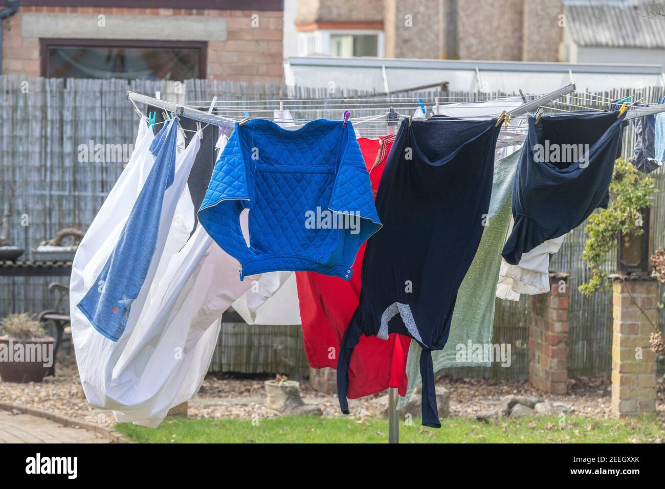 Washing hang on a rotary cloths line blowing in the wind in a backgarden, Northampton, England, UK. Stock Photo