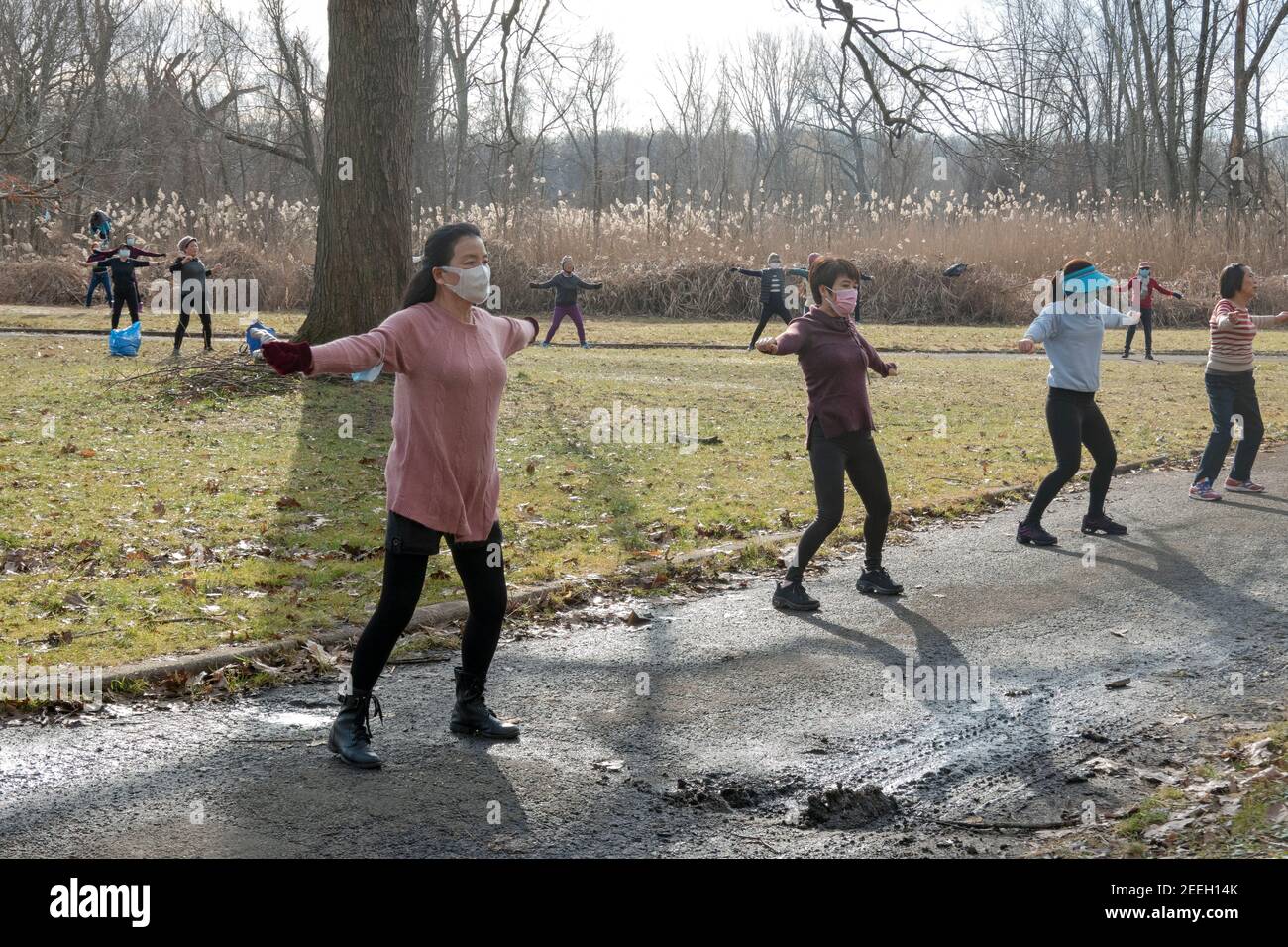 On a mild winter morning, Asian American women, primarily Chinese, attend a dance exercise class in a park in Flushing, Queens, New York City. Stock Photo
