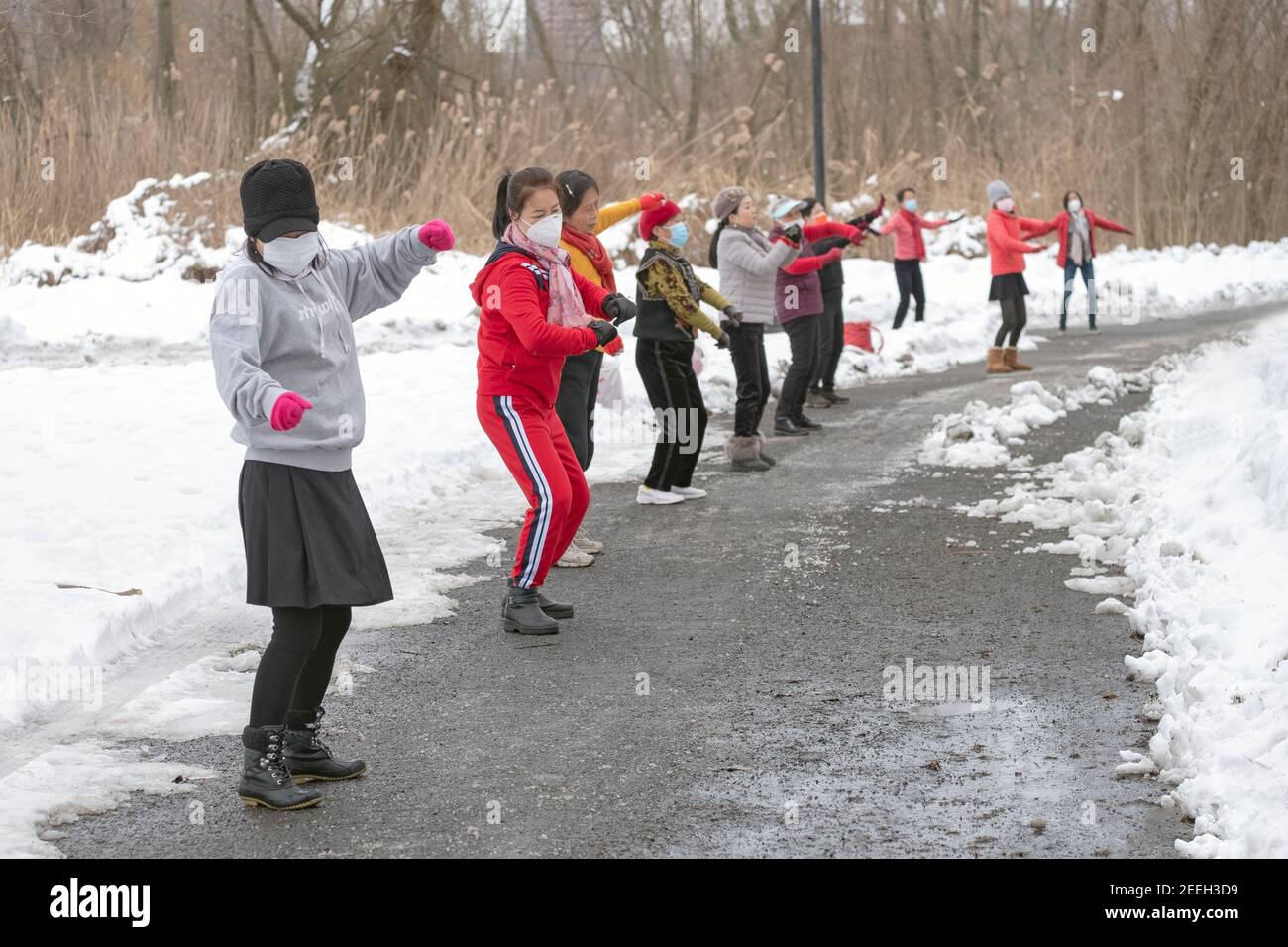 On a cold winter morning, Asian American women, primarily Chinese, attend a dance exercise class in a park in Flushing, Queens, New York City. Stock Photo