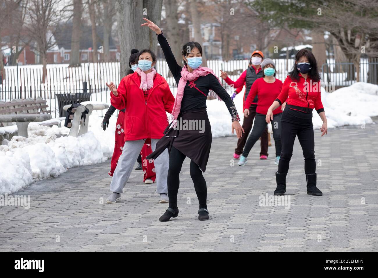 A slender graceful Chinese American woman teaches a dance exercise class in a park in Queens, New York City. Stock Photo