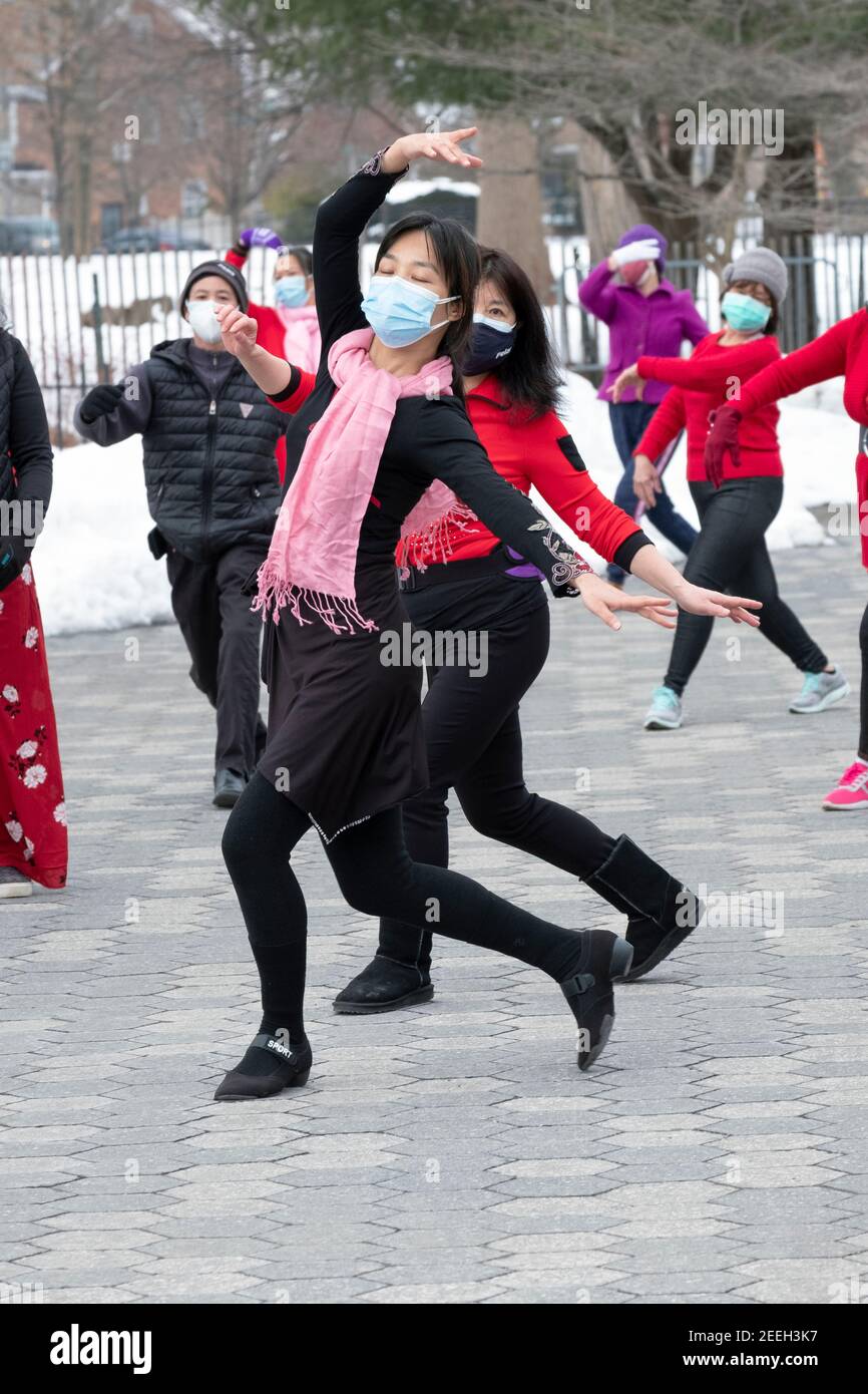 A slender graceful Chinese American woman teaches a dance exercise class in a park in Queens, New York City. Stock Photo