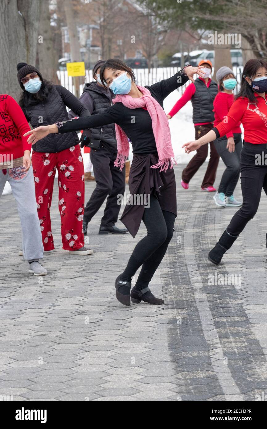 A slender graceful Chinese American woman teaches a dance exercise class in a park in Queens, New York City. Stock Photo