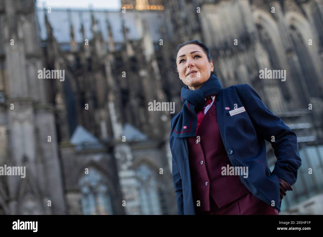Cologne, Germany. 11th Feb, 2021. Nadine Perlinger dos Santos, former stewardess at Lufthansa subsidiary Germanwings and now a train attendant at Deutsche Bahn, is facing the dome. Job prospects for pilots, flight attendants and aircraft technicians have deteriorated massively in the Corona crisis. In the reorientation, a state-owned company apparently offers advantages. (to dpa 'From the jet to the ICE - Flying personnel highly welcome at Deutsche Bahn') Credit: Rolf Vennenbernd/dpa/Alamy Live News Stock Photo